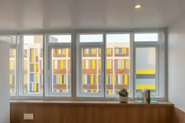 Detailed view of a secondary glazing installation in a London office setting, showing how the discreet frame sits inside the existing window reveal.