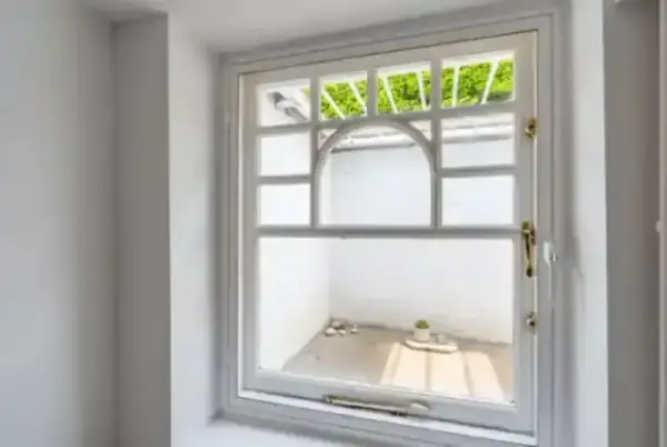 Bespoke arched secondary glazing that perfectly matches the original window architecture in a period property
